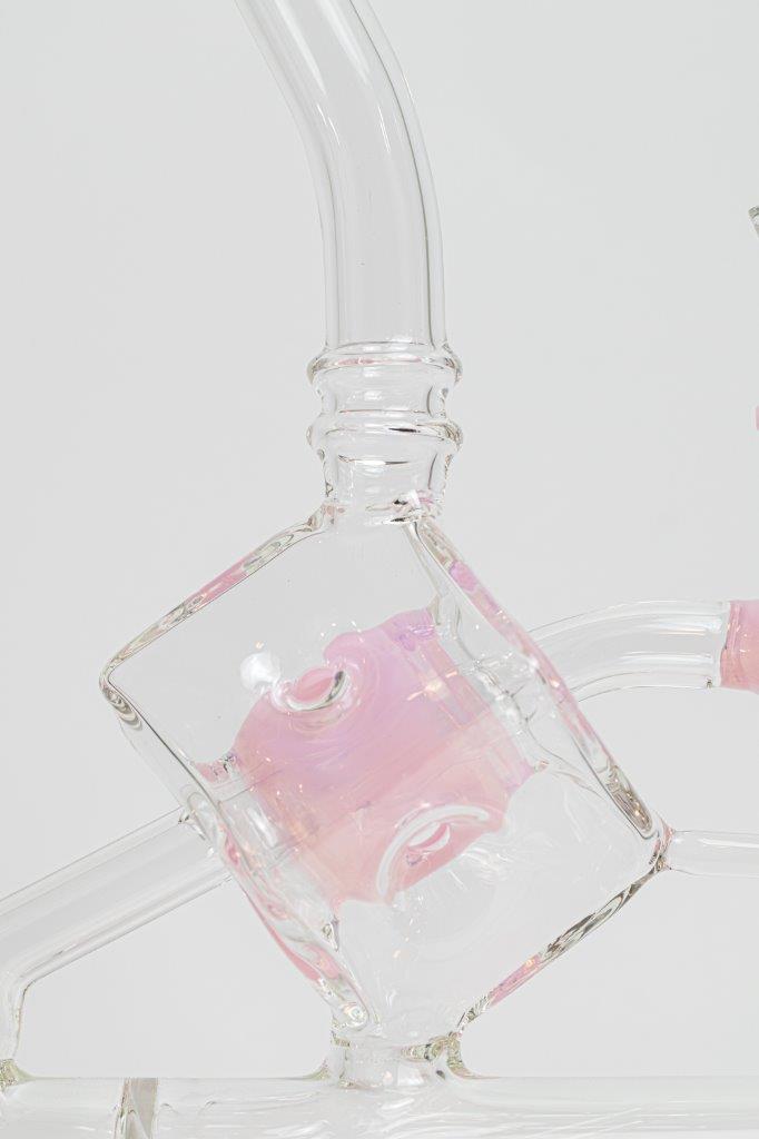 Pink Incline Water Pipe – an 10-inch cube-designed wonder perfect for weed and dabs. Now available for sale, this distinctive piece includes a 14MM male bowl for weed, a bent-down stem, and a bubble percolator, providing a unique smoking experience with efficient filtration. The percolator prevents water from splashing back into your mouth, cools the smoke down