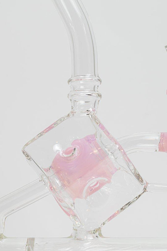 Pink Incline Water Pipe – an 10-inch cube-designed wonder perfect for weed and dabs. Now available for sale, this distinctive piece includes a 14MM male bowl for weed, a bent-down stem, and a bubble percolator, providing a unique smoking experience with efficient filtration. The percolator prevents water from splashing back into your mouth, cools the smoke down