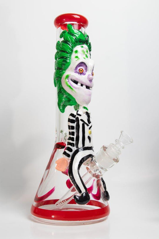 14-inch Killing Clown Bong – a water pipe with a twisted design for weed and dabs in water breaker style glass. For sale now, this unique piece features a Killing Clown design shape, a 14MM male bowl piece for weed, and a straight down stem, 