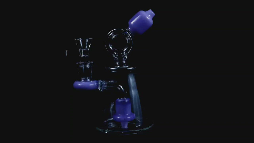 6.25-inch Purple Donut Recycler – the ultimate companion for weed and dabs in water bong style glass. Now for sale, this dope recycler features a 14MM male bowl piece for weed and a bent down stem