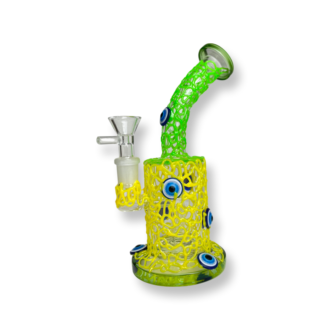 7.25 inch Eye Design Water Rig – the enthusiastic stoner's essential now available for purchase. Crafted with a male standard 14mm bowl piece, a bent down stem, and a sturdy base, this water rig is as sturdy as it is stylish. Dive into the world of unique smoking experiences with this affordable and eye-catching rig Can be use for dabs/dry herb  . Quality glass  